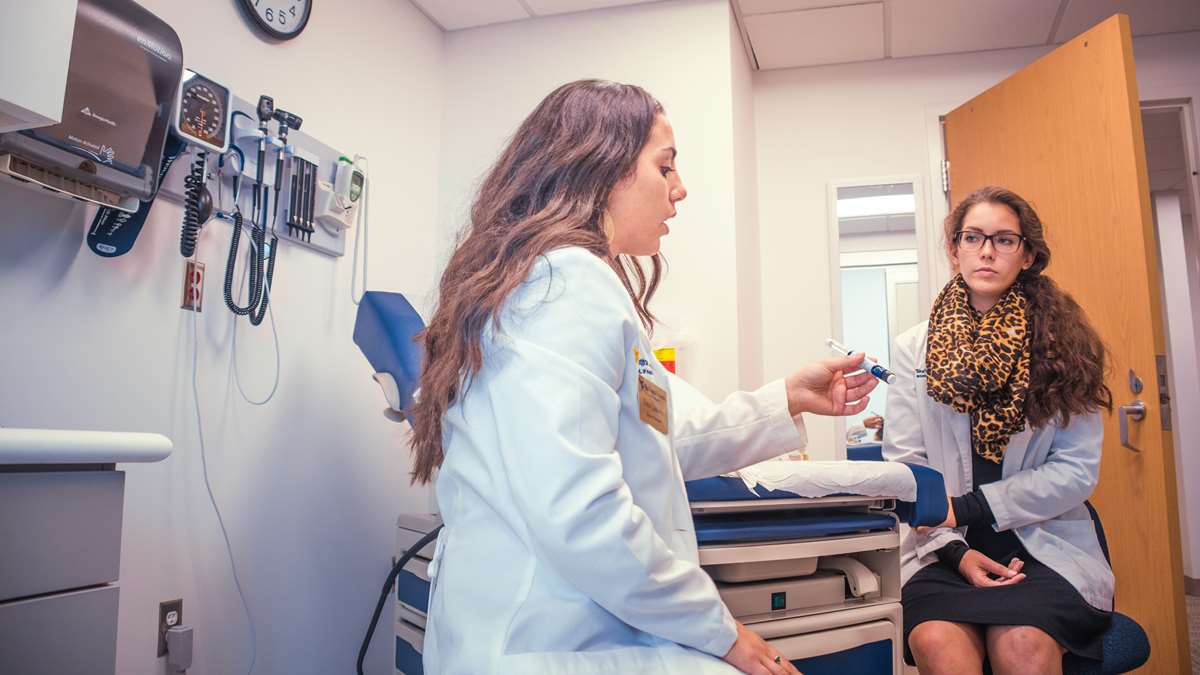 Pharmacy students consult with a mock patient scenario at the WVU Health Sciences Center.